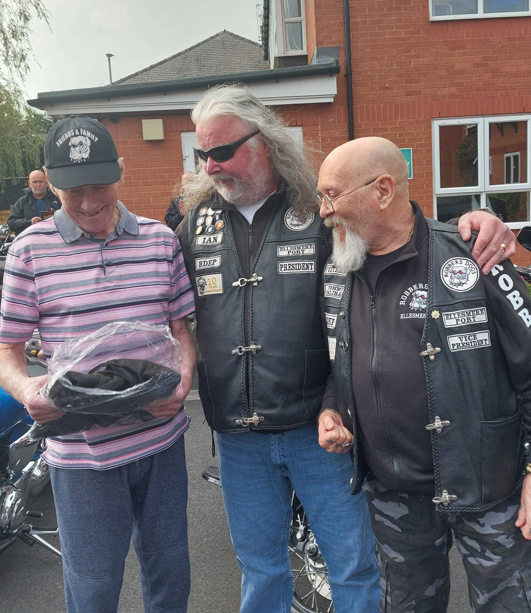 Aaron Court Care Home resident Spike Maloney (left) receives gifts from two members of the Robbers Dogs community motorcycle group for his 77th birthday.