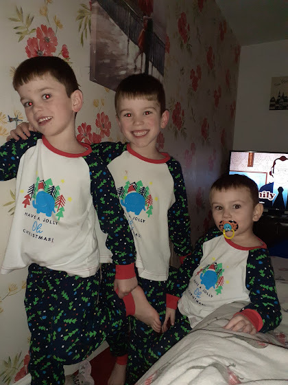 Jaxon, Eli and Dylan Crawford in Christmas pyjamas.