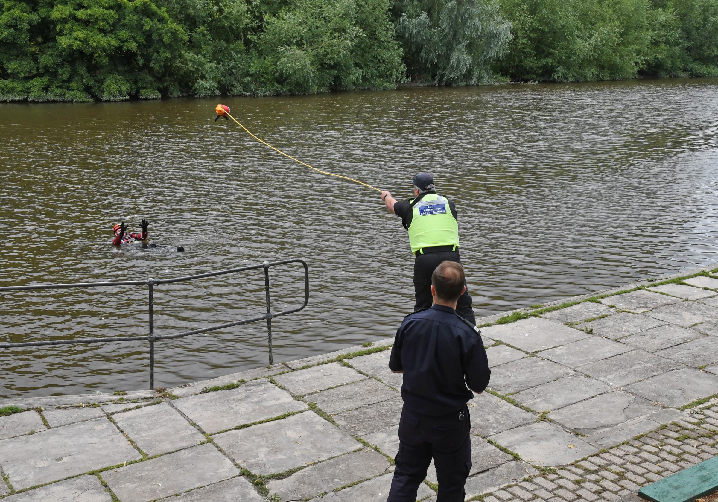 The rescue at the River Dee, with a community safety warden demonstrating how to throw the rope accurately.