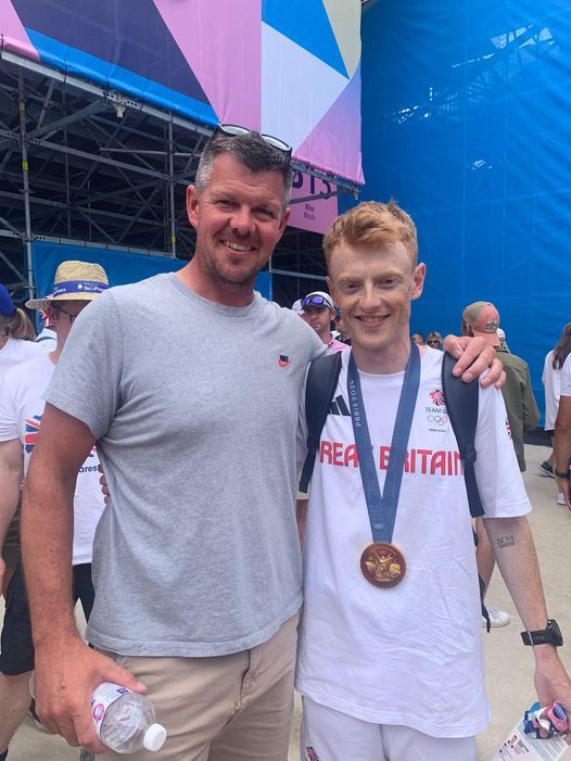 Harry Brightmore is pictured shortly after his win with Kings School rowing coach, Matt Jump.