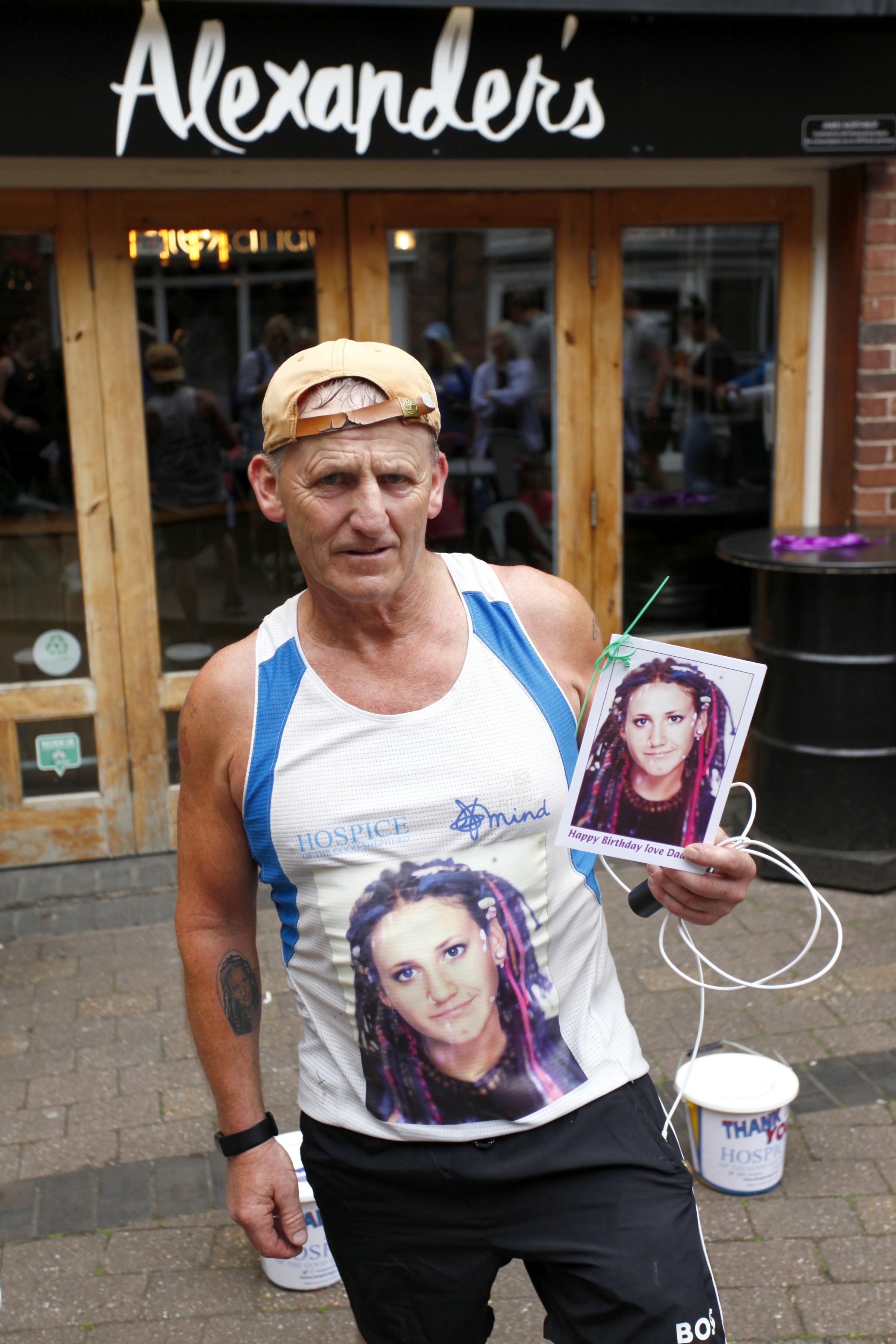 John Jennings after completing 34.5 miles, with the photo of his much-missed daughter Michelle Jennings. Pictures: Jeff Price.