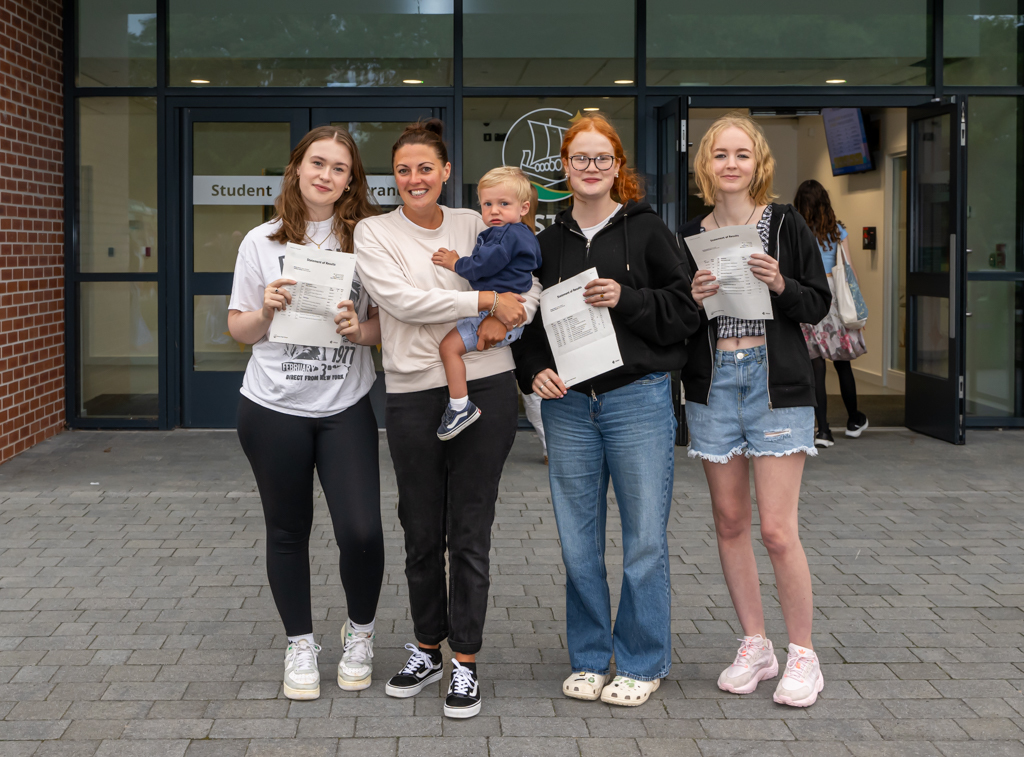 Neston High School students celebrate their A-level results.