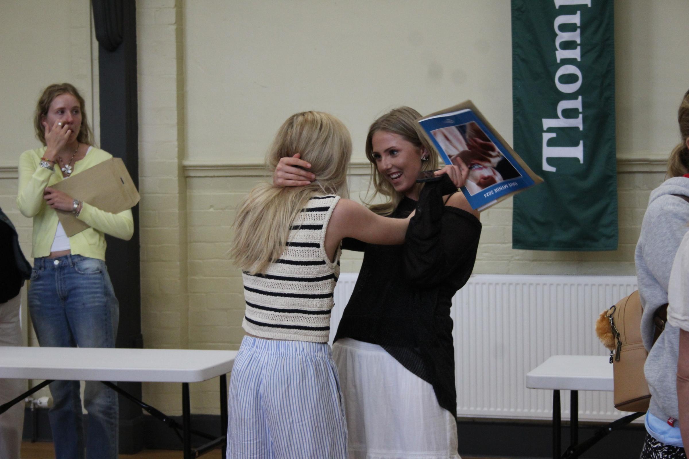 Friends Hollie Tempero and Scarlett Toovey congratulate each other on their results.