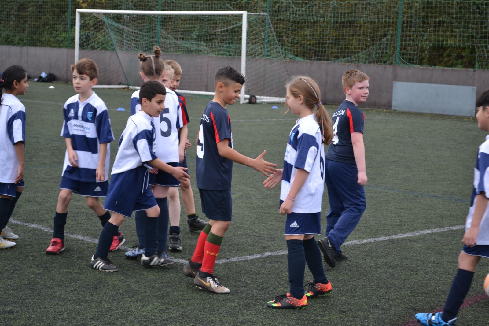 Pupils congratulate each other on a fun-filled football festival.