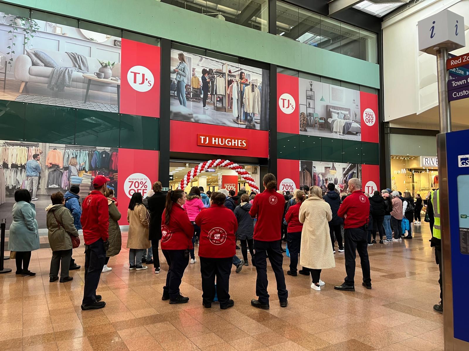 Shoppers queue to be the first to enter the new TJ Hughes store