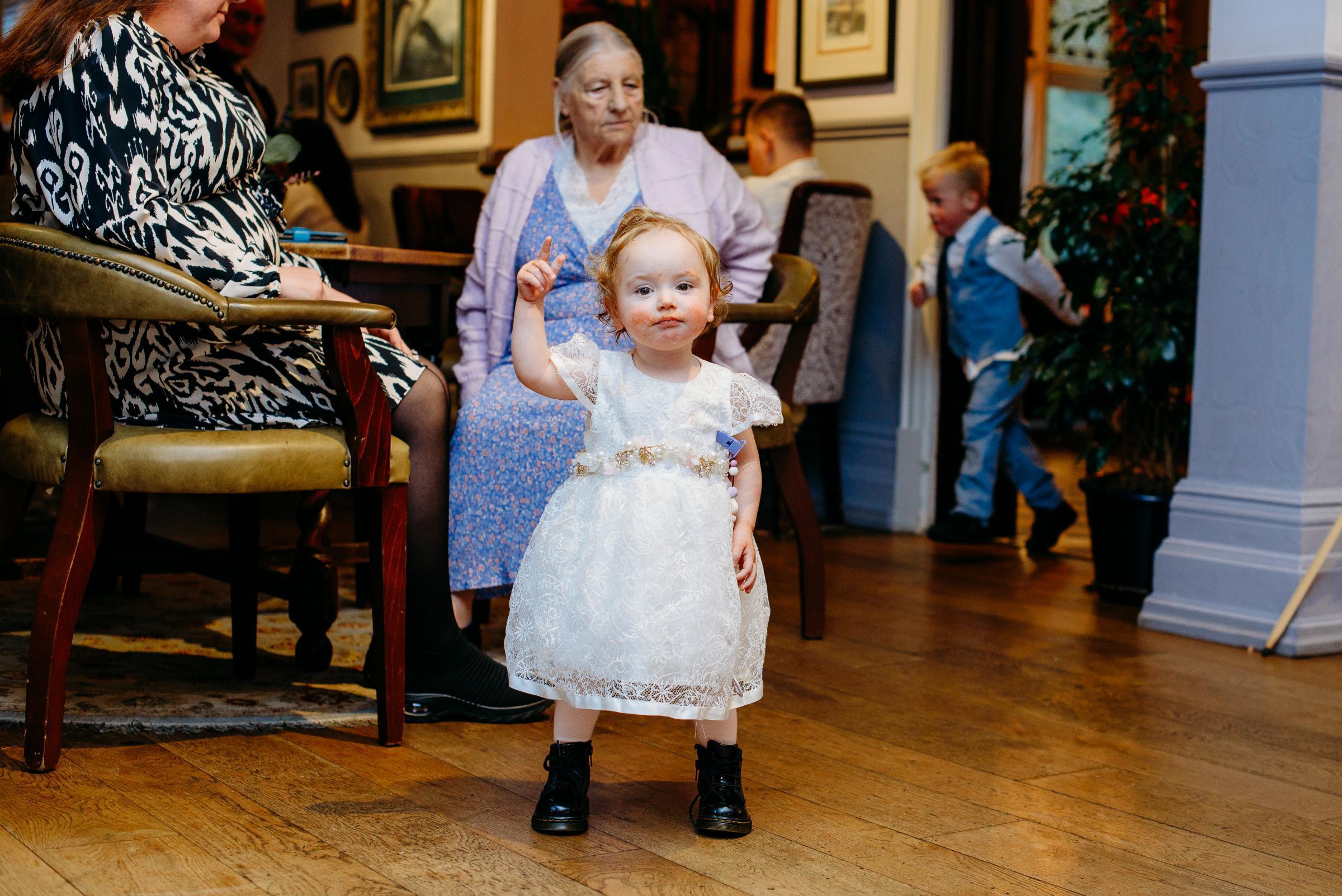 Flower girl ready to part, Willow Solari, with Ann Evans behind.